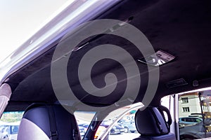 The ceiling of the SUV car pulled by black Alcantara material in