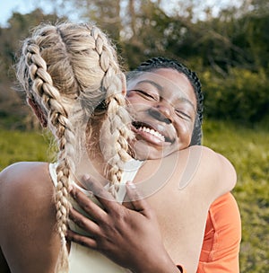 We celebrate each others achievements. an attractive young woman standing and hugging her friend during their outdoor