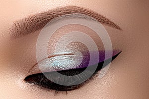 Celebrate Macro Eyes with Smoky Cat Eye Makeup. Cosmetics and Make-up. Closeup of Fashion Visage with Liner, Eyeshadows photo