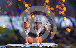 Celebrate New Years eve in home garden outdoors in winter  snowy evening  sparklers sparkle.