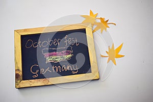 Celebrate october festival - clothes pins on grey/white background and a chalkboard with the slogan `October Fest Germany`