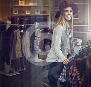Celebrate your day off with a shopping spree. a young woman shopping at a clothing store.
