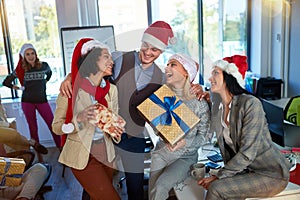 Celebrating Christmas in office..Group people in santa hat at Xmas business party