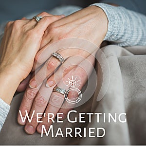 Celebrating love and commitment, the image showcases intertwined hands adorned with engagement rings