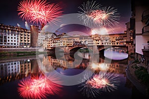 celebrating New year& x27;s eve in Florence, Italy - explosive fireworks around ponte vecchio on river arno