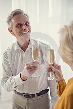 Celebrating pensioners holding sparkling wine