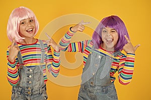 Celebrating something special. Happy girls celebrating together on yellow background. Small children celebrating and