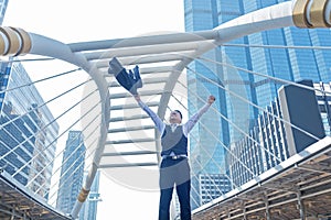 Celebrating success. Businessman keeping arms raised