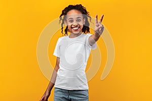 Portrait of smiling black girl showing peace sign