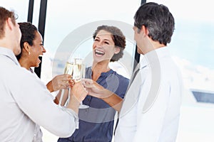 Celebrating their companys success. a group of businesspeople toasting to their success with champagne.