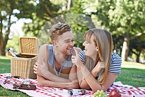 Celebrating their love with a picnic. A young couple having a picnic.