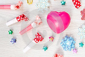 Celebration above various party confetti with pink heart