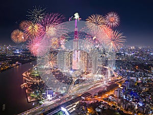 Celebration. Aerial view of Landmark 81 skyscraper with fireworks light up sky over business district in Ho Chi Minh City, Vietnam photo