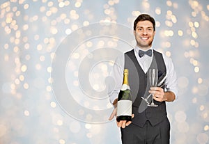 Man with bottle of champagne and glasses at party