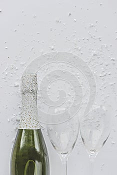 Celebration background: bottle of champagne and two empty glasses