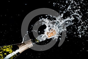 Celebration of birthday, anniversary or Christmas theme. Explosion of splashing champagne sparkling wine with flying cork out of t