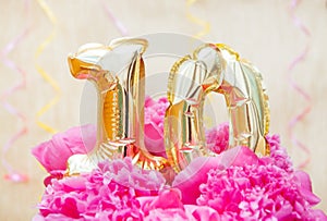 Celebration card with glitter air balloons of number 10 ten in pink peony flowers on golden background