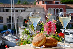 Celebration with champagne sparkling wine and french stuffed with apples or chocolate beignets donuts pastry, sweet dessert served