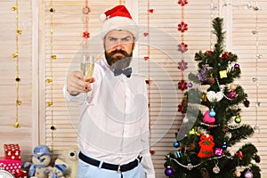 Celebration and cheers concept. Guy near Christmas tree
