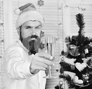 Celebration and cheers concept. Santa Claus in hat holds champagne