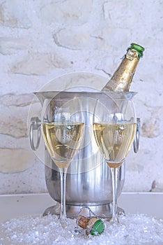 Celebration concept: two glasses of champagne and vintage bottle in the bucket