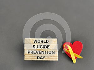 Celebration Day Concept - world suicide prevention day text on wooden blocks with gray background. Stock photo.