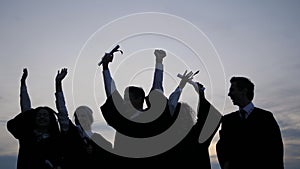 Celebration Education Graduation Student Success Learning Concept. Silhouette of students tossing caps in the air.