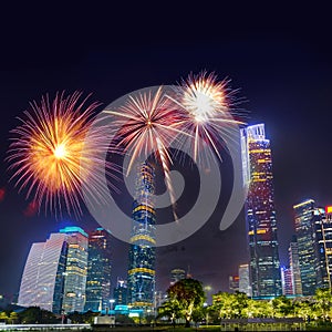 Celebration firework in twilight night cityscape of guangzhou urban skyscrapers at storm with lightning  bolts in night purple