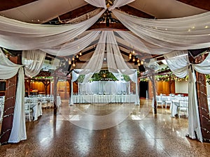 Celebration hall decorated with white drapes