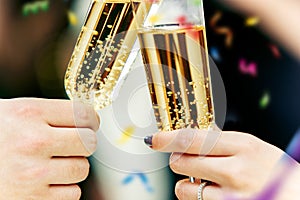 Celebration. Hands holding the glasses of champagne and wine making a toast.