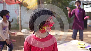 Celebration of Holi festival day colorful footage of Group of Cheerful kids playing holi