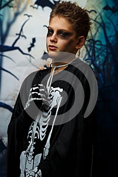 Celebration of holiday Halloween, the cute 8 year boy  in the image, costume, the skeleton theme, the vampire, bat concept