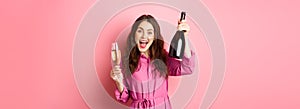Celebration and holidays concept. Happy woman dancing and having fun, drinking champagne, holding bottle and glass