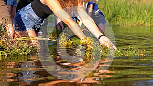 Celebration of Ivan Kupala. Girls and women lay wreaths on the water. Folk tradition
