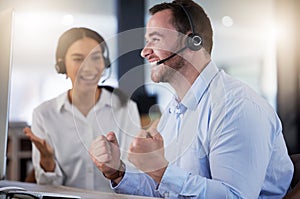 Celebration, man and woman with headset, call centre and winner of target, telemarketing and email on computer. Agency