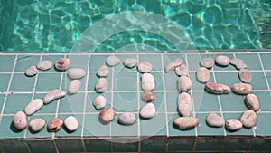 Celebration of new year,Date 2019 is laid out by pebble stones on the edge of the pool in the tropical resort