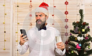 Celebration and New Year greetings concept. Santa Claus with phone