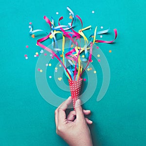 Celebration,party backgrounds concepts ideas with hand holding colorful confetti,streamers.