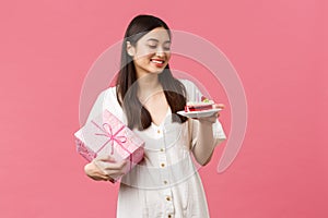 Celebration, party holidays and fun concept. Dreamy happy pretty birthday girl in white dress, smiling and looking away