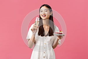 Celebration, party holidays and fun concept. Happy asian woman celebrating birthday enjoying tasty b-day cake and