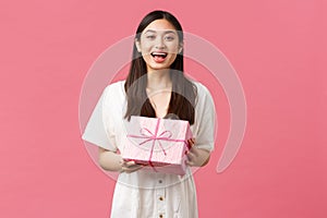 Celebration, party holidays and fun concept. Happy grateful cute asian girl celebrating birthday, receive b-day gift and