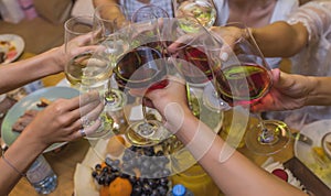 Celebration. People holding glasses of white wine making a toast.