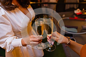 Celebration. People holding glasses of white wine making a toast.