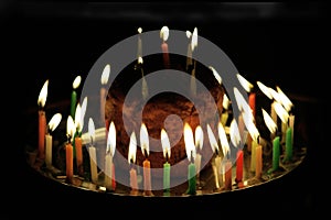 A celebratory cake with burning candles