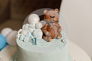 Celebratory cake for a children\'s birthday in blue with a teddy bear