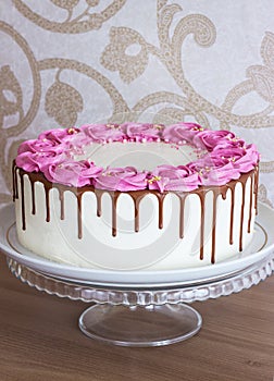 Celebratory cake with cream roses and chocolate
