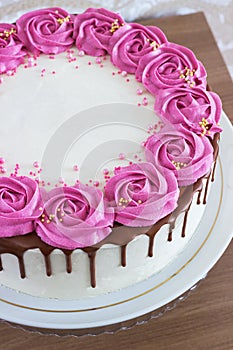 Celebratory cake with cream roses and chocolate