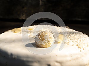 Celebratory cake with white cream and nuts