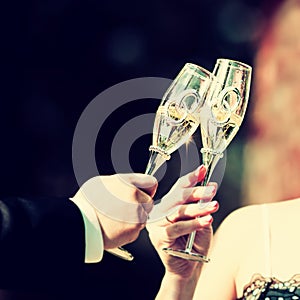 Celebratory glass of champagne in hand of bride,vintage