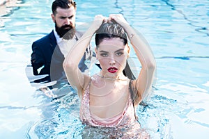 Celebrity couple, fashionable pair of elegant people. Romantic couple on Party in swimming pool. Concept of relations